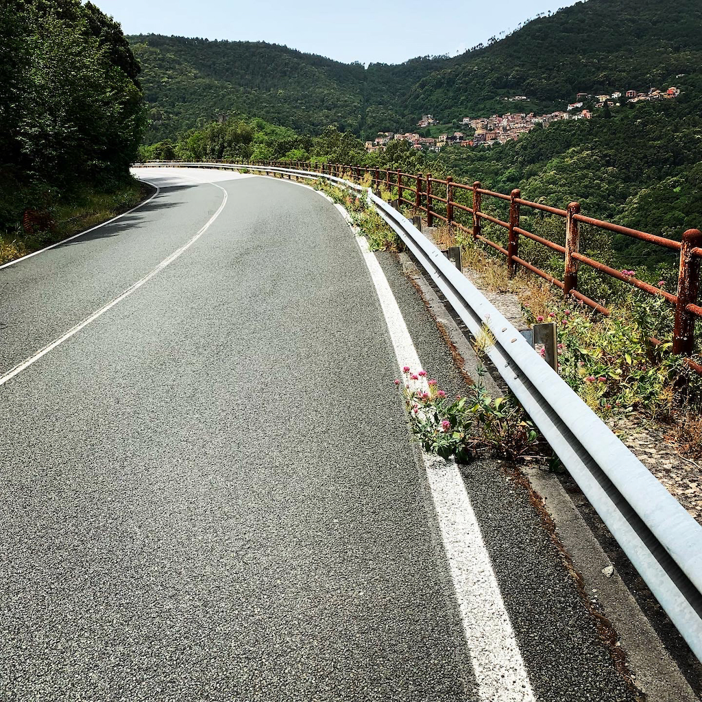 En nerförsbacke av en asfalterad vägsträcka mellan Porto Venere och La Spezia