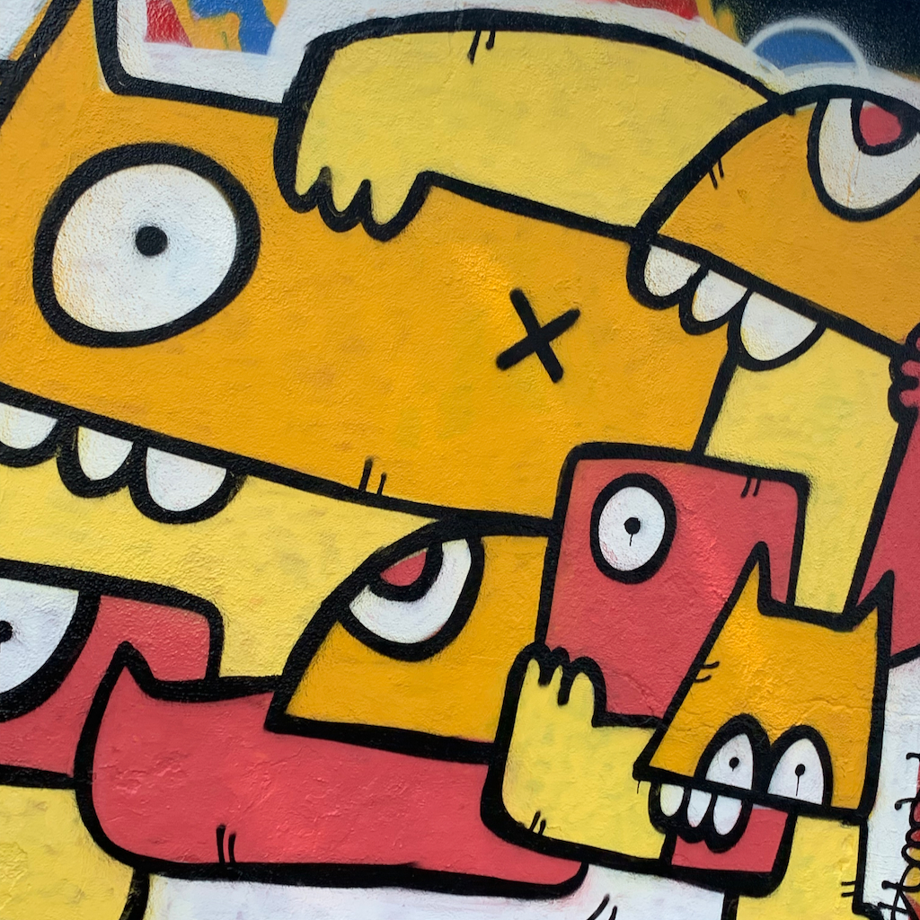 Street Art i form av grafitti som föreställer grafiska färgglada hundar på Passeig de Circumval-Lacia i spanska Barcelona