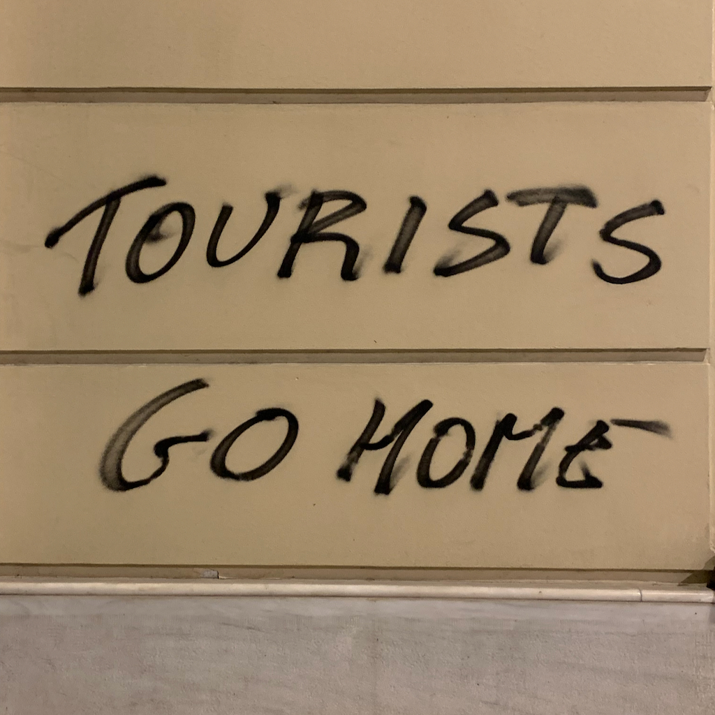 Tourists Go Home klottrat på en vägg i stadsdelen Exharchia i Aten.